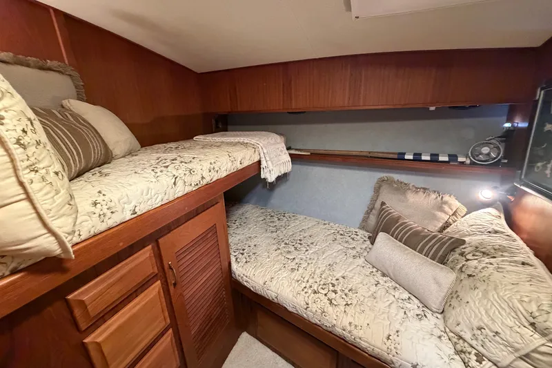 Slide: The Image of Cozy cabin interior of 1986 Viking 48 Motor Yacht with twin beds and wooden cabinetry. - 29