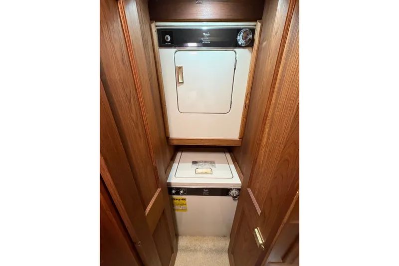 Slide: The Image of Laundry area with washer and dryer inside a 1986 Viking 48 Motor Yacht. - 21