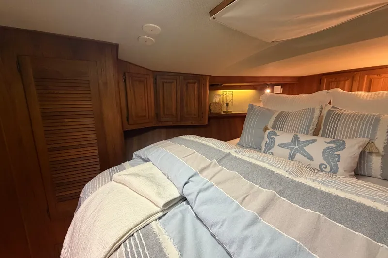 Slide: The Image of Cozy bedroom interior of 1986 Viking 48 Motor Yacht with nautical-themed bedding. - 38