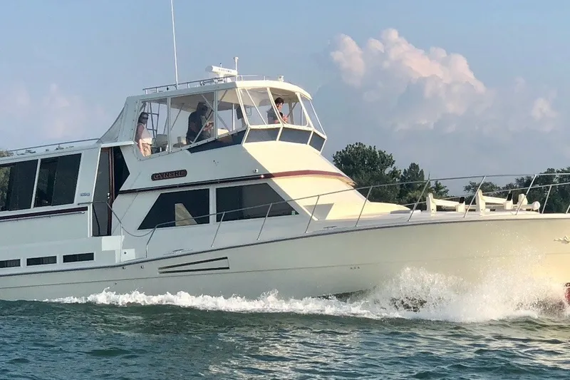 The Image of 1986 Viking 48 Motor Yacht cruising on open water, showcasing sleek design and spacious deck. - 1
