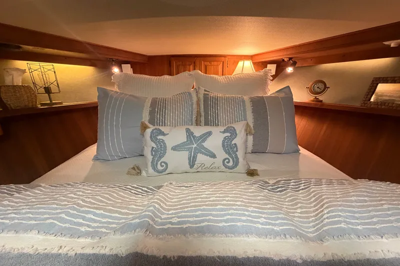 Slide: The Image of Cozy bedroom interior of 1986 Viking 48 Motor Yacht with nautical-themed decor. - 37
