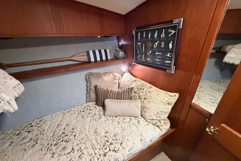 Slide: The Image of Cozy cabin interior of 1986 Viking 48 Motor Yacht with nautical decor and plush bedding. - 31