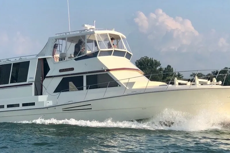 Slide: The Image of 1986 Viking 48 Motor Yacht cruising on water with passengers onboard. - 45