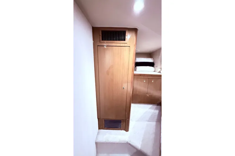 Slide: The Image of Interior of 2002 Viking 52 Convertible yacht with wooden cabinetry and soft lighting. - 57