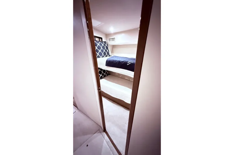 Slide: The Image of Interior view of 2002 Viking 52 Convertible yacht with bunk beds and modern decor. - 38