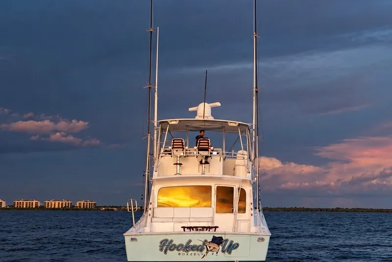 Slide: The Image of 2002 Viking 52 Convertible yacht on water at sunset with dramatic sky. - 9