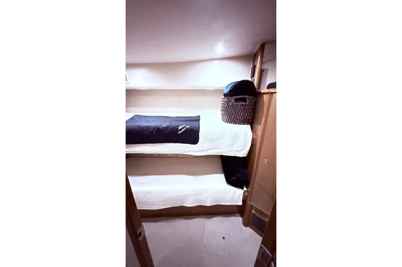 Slide: The Image of Interior of 2002 Viking 52 Convertible yacht with cozy bunk beds and storage basket. - 43
