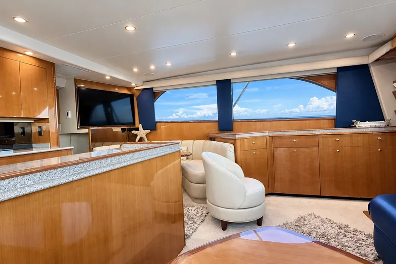 Slide: The Image of Luxurious interior of a 2002 Viking 52 Convertible yacht with elegant wood finishes and ocean view. - 36