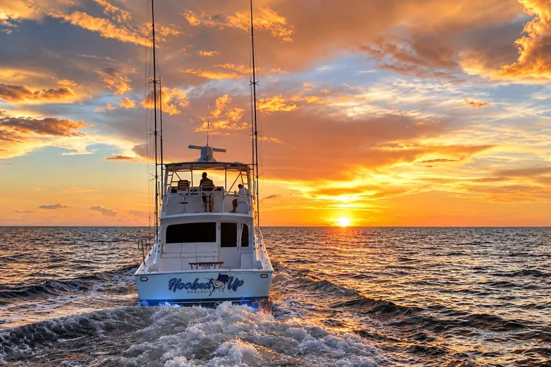 Slide: The Image of Viking 52 Convertible yacht cruising at sunset, 2002 model, vibrant ocean scene. - 10