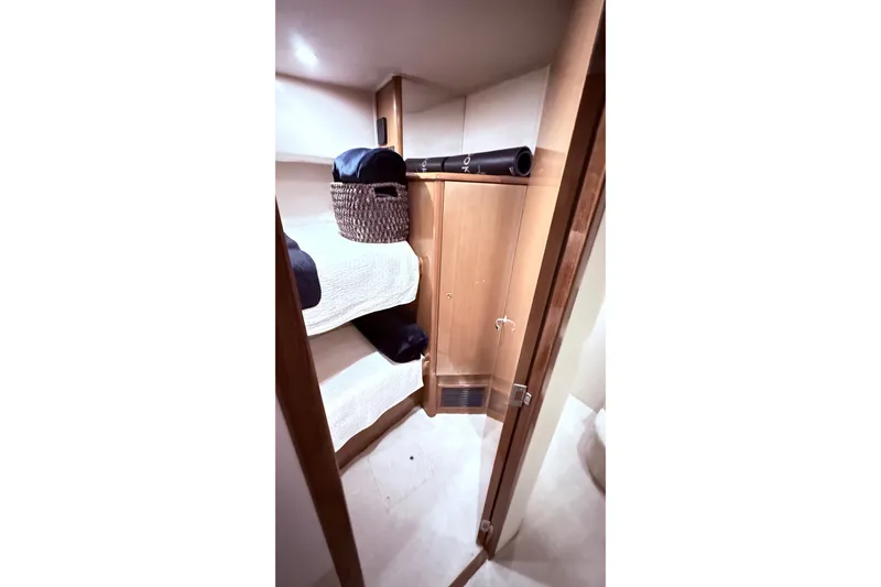 Slide: The Image of Interior cabin of 2002 Viking 52 Convertible yacht with bunk beds and storage. - 41