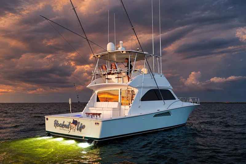 Slide: The Image of 2002 Viking 52 Convertible yacht on water at sunset with dramatic clouds. - 21