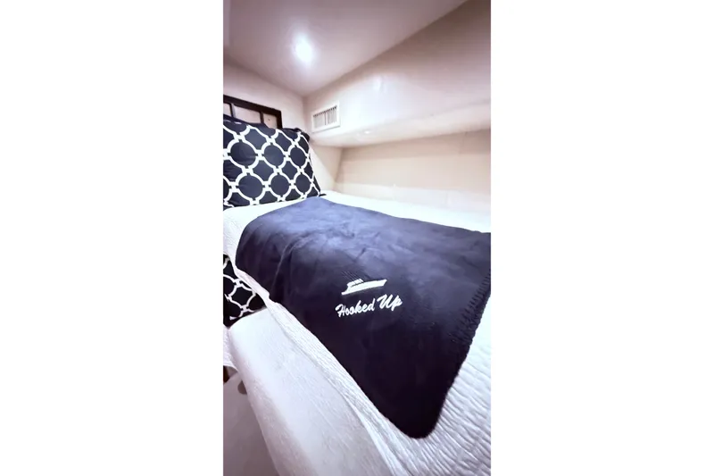 Slide: The Image of Luxurious cabin interior of a 2002 Viking 52 Convertible yacht with stylish bedding. - 40