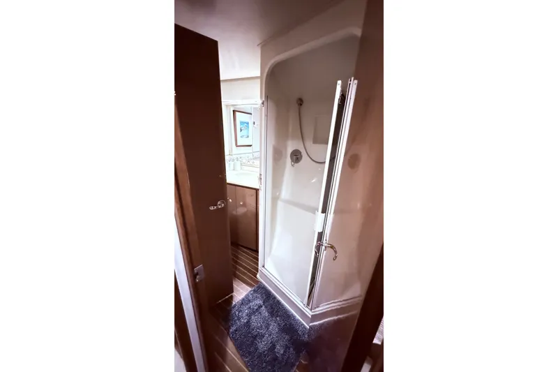 Slide: The Image of Bathroom interior of 2002 Viking 52 Convertible yacht, featuring a shower and vanity. - 45