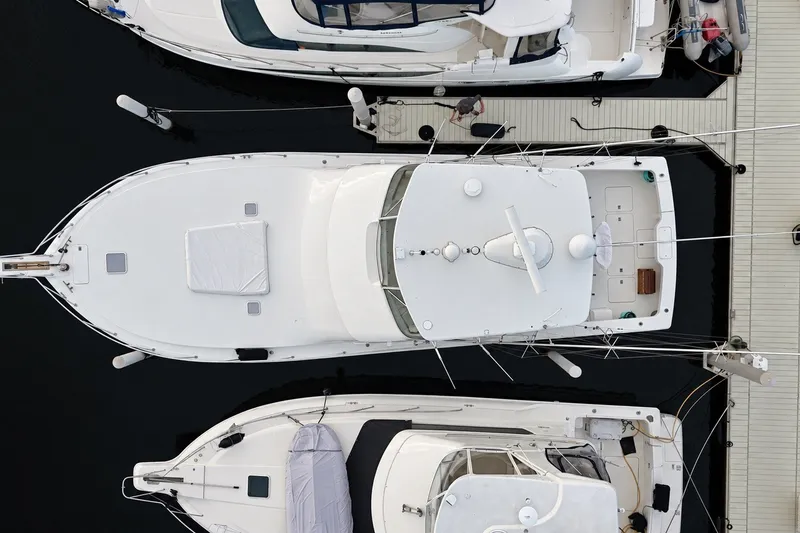 Slide: The Image of Aerial view of a 2002 Viking 52 Convertible yacht docked among other boats. - 29