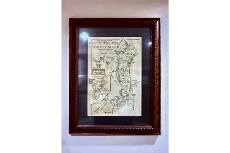 Slide: The Image of Framed vintage map of Man of War Cay and Cherokee Sound, highlighting nautical routes. - 56