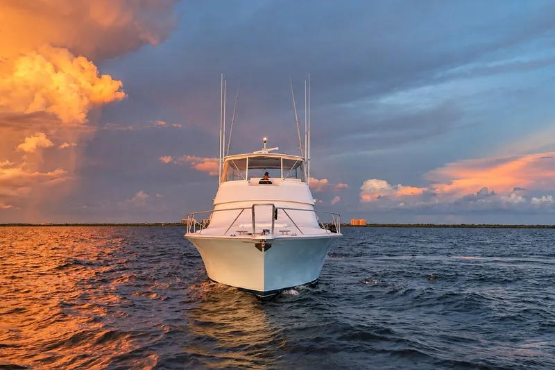 Slide: The Image of Viking 52 Convertible yacht on water at sunset, 2002 model. - 12