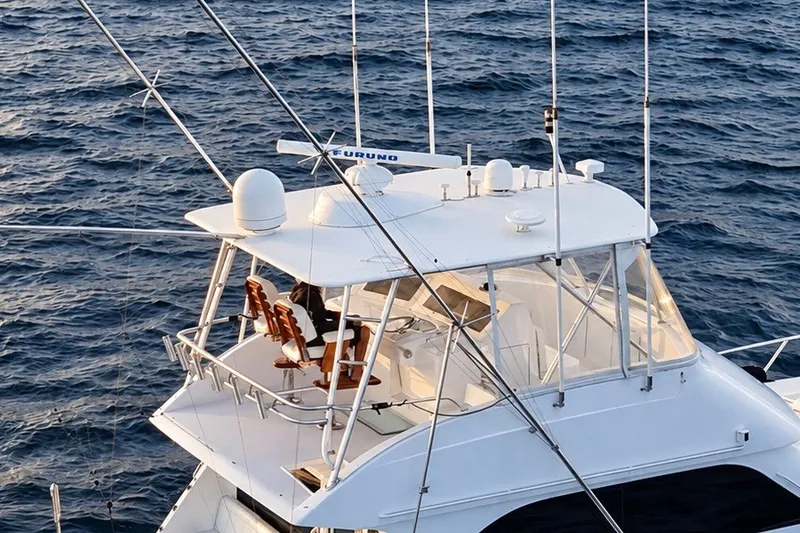 Slide: The Image of 2002 Viking 52 Convertible yacht navigating ocean waters, featuring a spacious flybridge. - 27