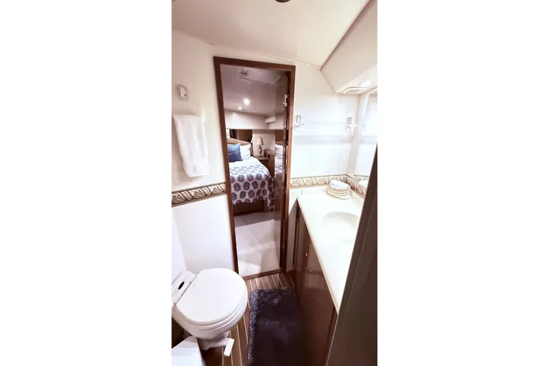 Slide: The Image of Bathroom and bedroom interior of 2002 Viking 52 Convertible yacht, featuring modern amenities. - 53