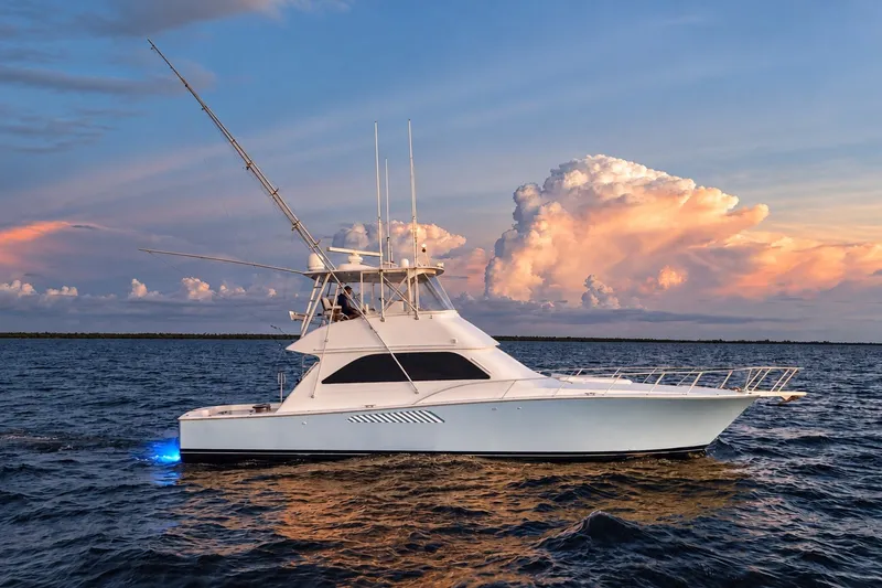 Slide: The Image of 2002 Viking 52 Convertible yacht on ocean at sunset with dramatic clouds. - 14