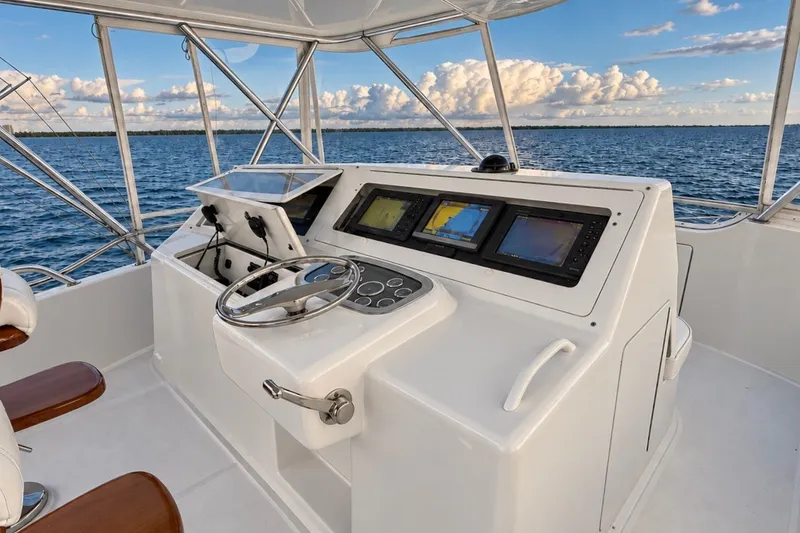 Slide: The Image of Cockpit of 2002 Viking 52 Convertible yacht with navigation screens and steering wheel. - 31