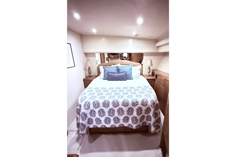 Slide: The Image of Luxurious bedroom interior of 2002 Viking 52 Convertible yacht with elegant bedding and soft lighting. - 48