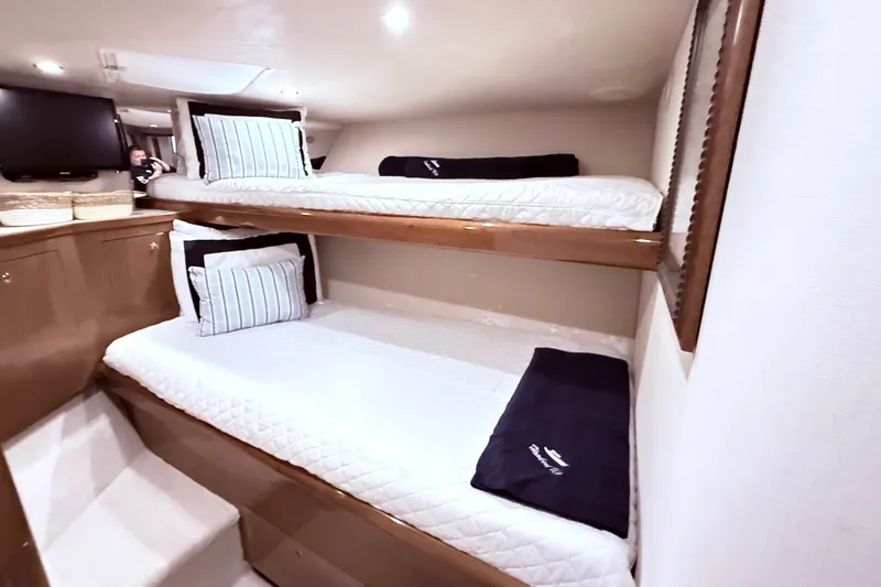 Slide: The Image of Interior of 2002 Viking 52 Convertible yacht with cozy bunk beds and modern decor. - 61