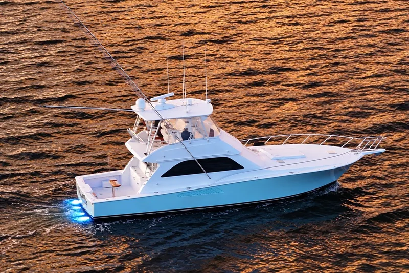 The Image of 2002 Viking 52 Convertible yacht cruising on sunset-lit waters. - 1