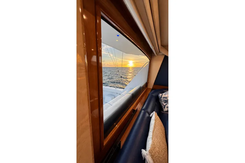 Slide: The Image of View of sunset over ocean from 2002 Viking 52 Convertible yacht window. - 33