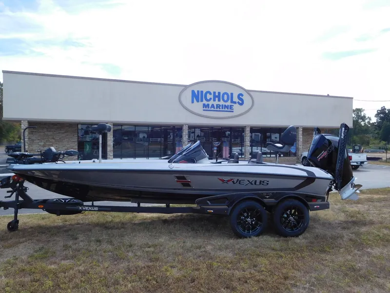 The Image of A 2027 Vexus VXs21 boat on a trailer in front of a building labeled "Nichols Marine." - 1
