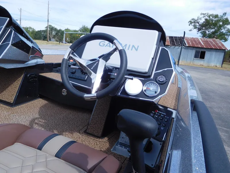 Slide: The Image of The image shows the cockpit of a 2027 Vexus VXs21 boat with a Garmin navigation system. - 21