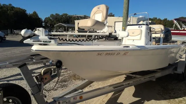 Slide: The Image of A white 2016 NauticStar 214 boat on a trailer, featuring a Minn Kota motor. - 2