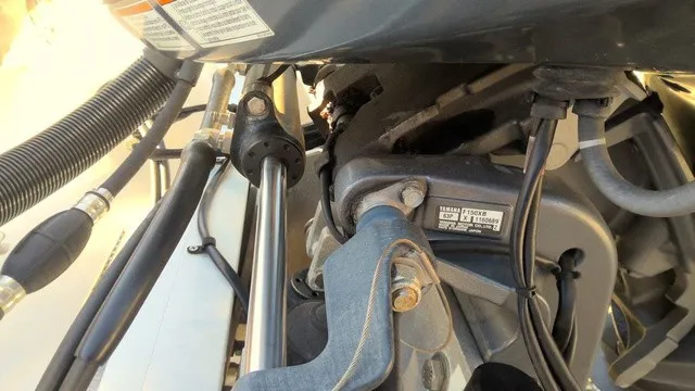 Slide: The Image of Close-up of a boat's outboard motor with cables and hoses. - 9