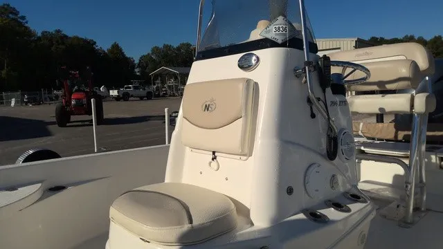 Slide: The Image of The image shows a 2016 NauticStar 214 boat with beige seating and a steering console. - 4