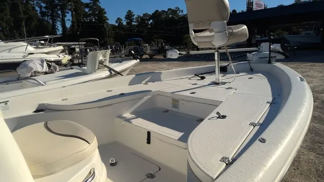 Slide: The Image of The image shows a 2016 NauticStar 214 boat with an open deck and seating. - 11