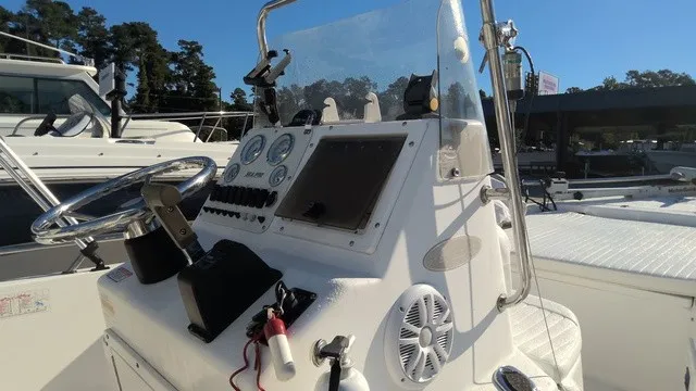 Slide: The Image of A 2004 Sea Pro 1900SV featuring a white helm with instruments and a steering wheel. - 4