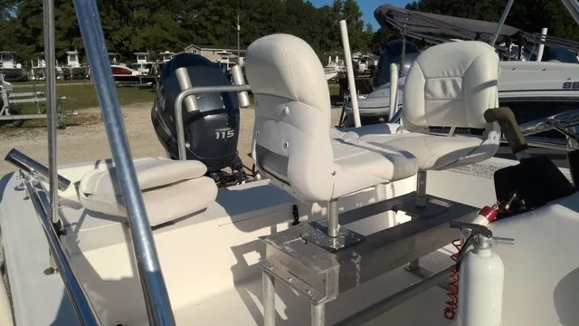 Slide: The Image of The image shows a 2004 Sea Pro 1900SV boat with white seats and an outboard motor. - 3