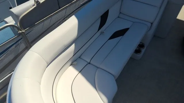 Slide: The Image of The image shows a white, curved seating area on a boat, with cup holders beside it. - 6