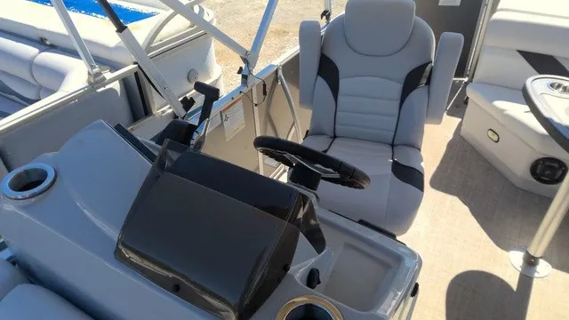 Slide: The Image of The image shows the cockpit of a 2023 SunCatcher Select 20C with a gray helm and cushioned seat. - 10