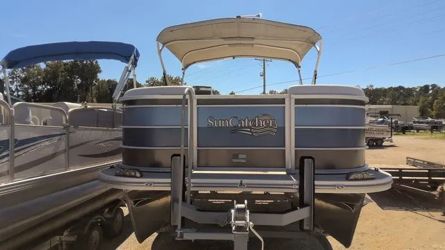 Slide: The Image of A 2023 SunCatcher Select 20C pontoon boat on a trailer under a blue sky. - 3