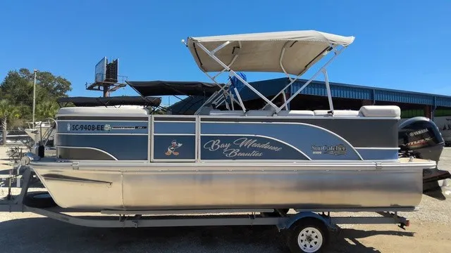 Slide: The Image of A 2023 SunCatcher Select 20C pontoon boat with a gray hull and sunshade. - 2