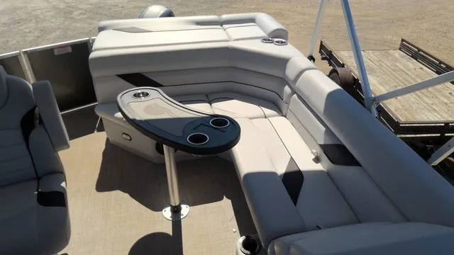Slide: The Image of The image shows the interior of a SunCatcher Select 20C pontoon boat with beige seating and a table. - 9