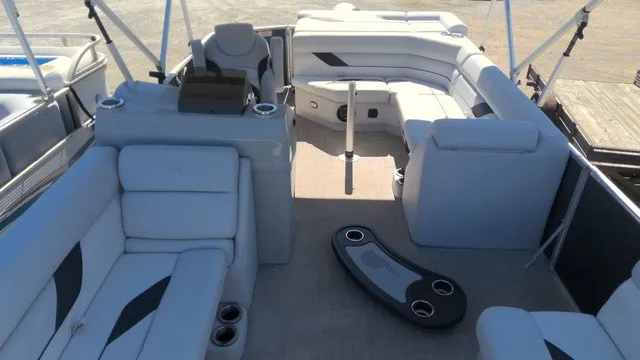 Slide: The Image of The image shows the interior of a SunCatcher Select 20C pontoon boat with gray upholstery and seating. - 5