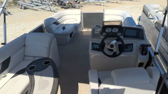 Slide: The Image of The image shows the cockpit of a 2023 SunCatcher Select 20C with comfortable seating and a modern helm. - 11