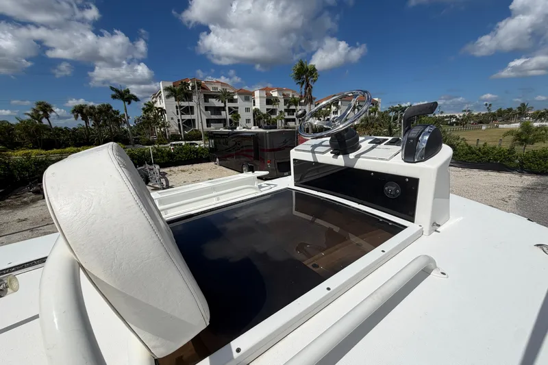 Slide: The Image of 2021 Caymas 28 HB boat helm with steering wheel and controls under a blue sky. - 20