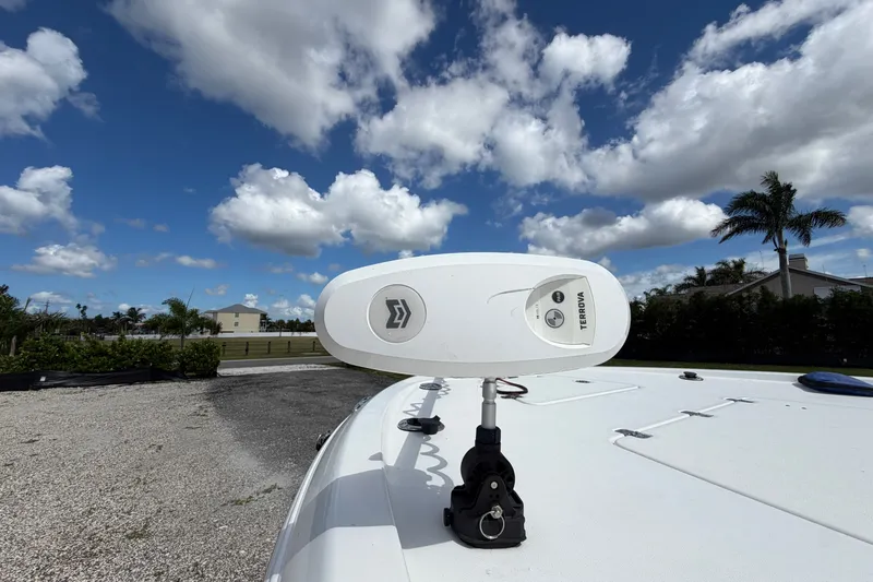 Slide: The Image of 2021 Caymas 28 HB boat with Terrova motor under a partly cloudy sky. - 23