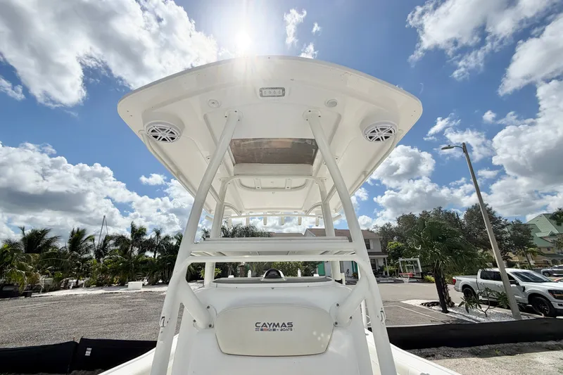 Slide: The Image of 2021 Caymas 28 HB boat with T-top under a bright blue sky. - 18