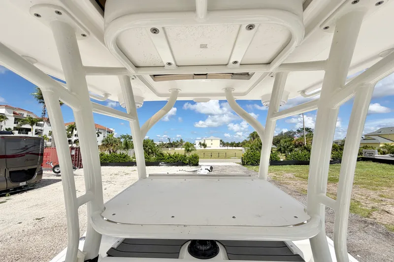 Slide: The Image of 2021 Caymas 28 HB boat interior with T-top and clear sky view. - 15