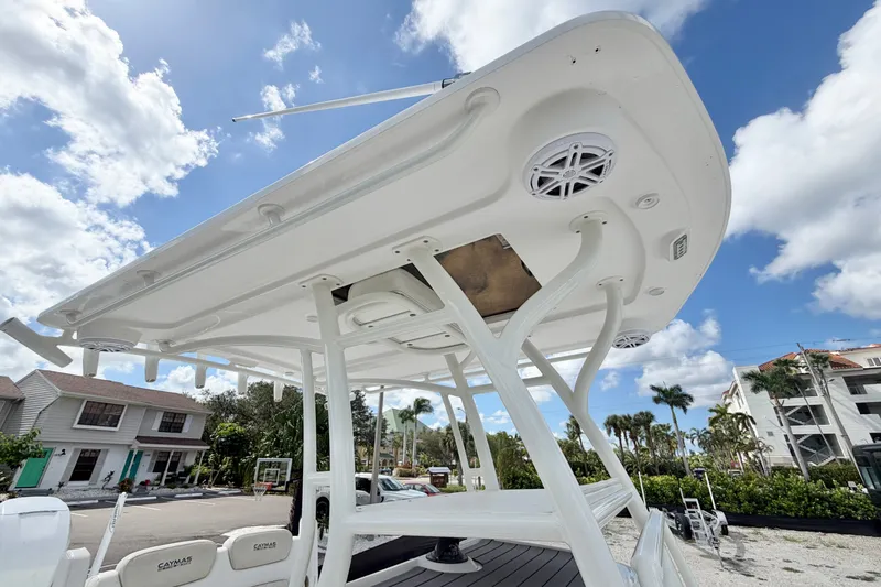 Slide: The Image of 2021 Caymas 28 HB boat with T-top and speakers under a clear sky. - 19