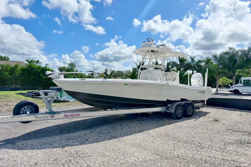 The Image of 2021 Caymas 28 HB boat on trailer under blue sky with clouds. - 0