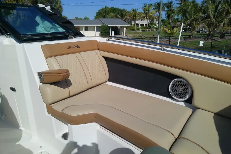 Slide: The Image of Luxurious seating on 2015 Sea Ray SDX 270 Outboard boat, featuring tan upholstery and speaker. - 31